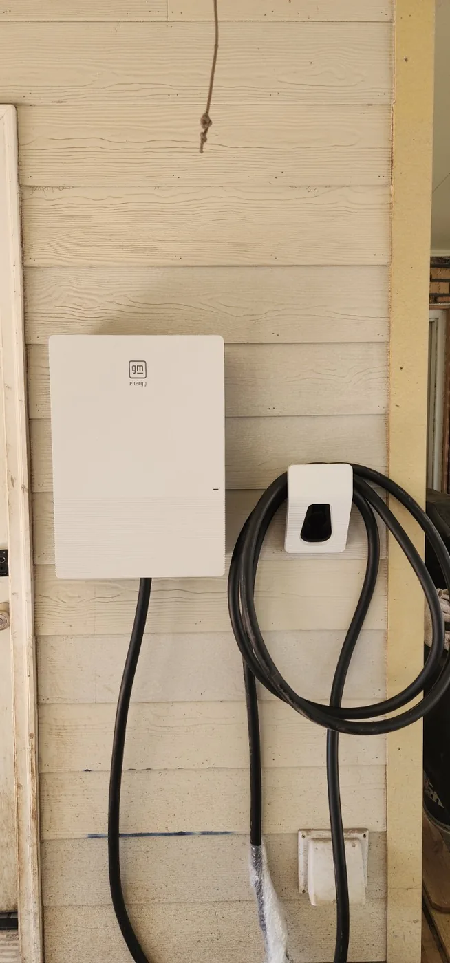 Home EV charging equipment installed on an exterior wall