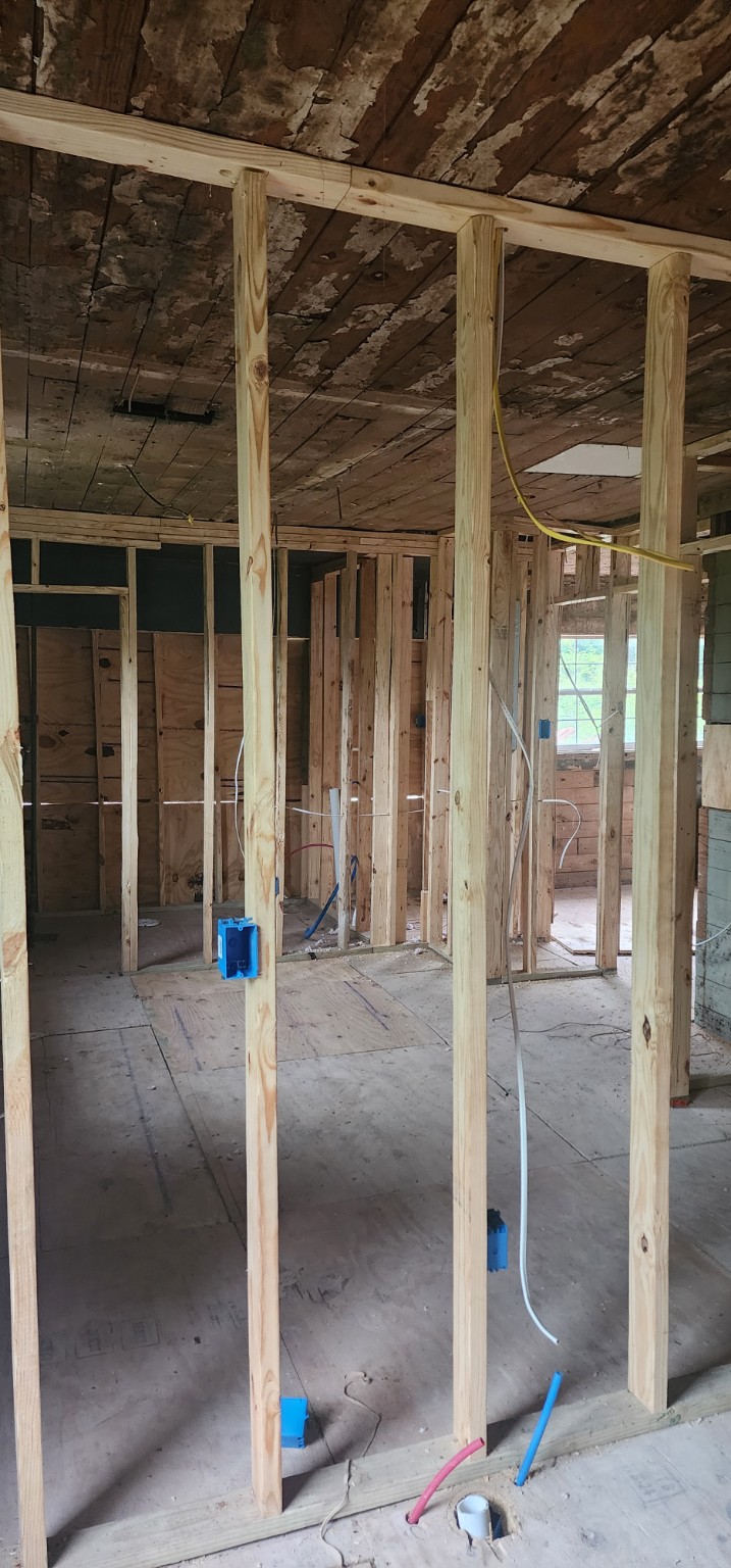 Open interior framing with electrical wiring and outlet boxes