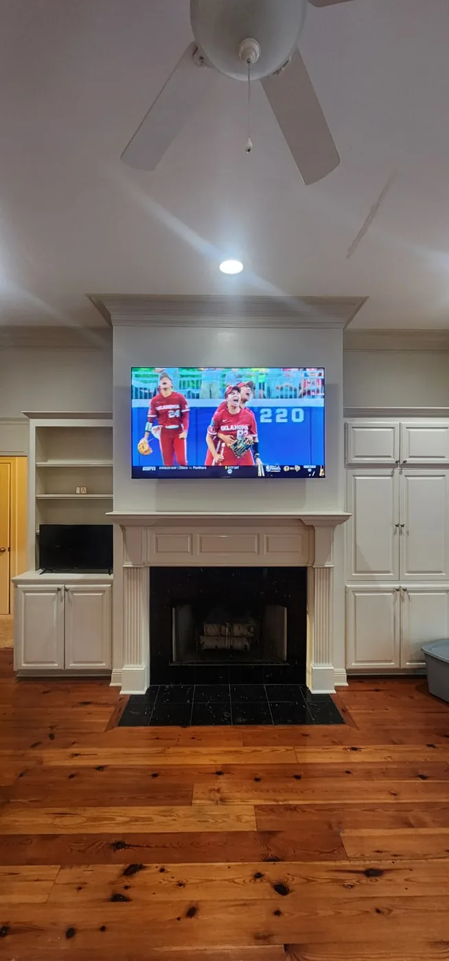 Finished TV mounted above a fireplace